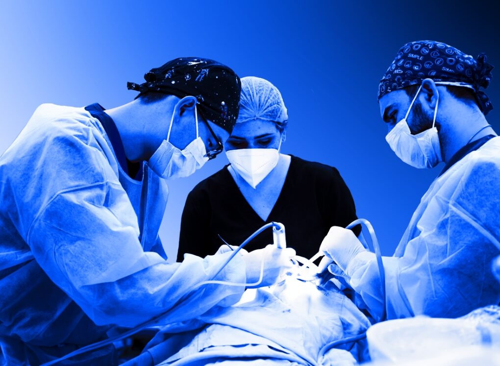 Surgical team placing implants in theatre